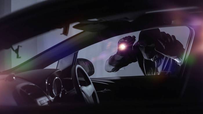 car thief looking inside car