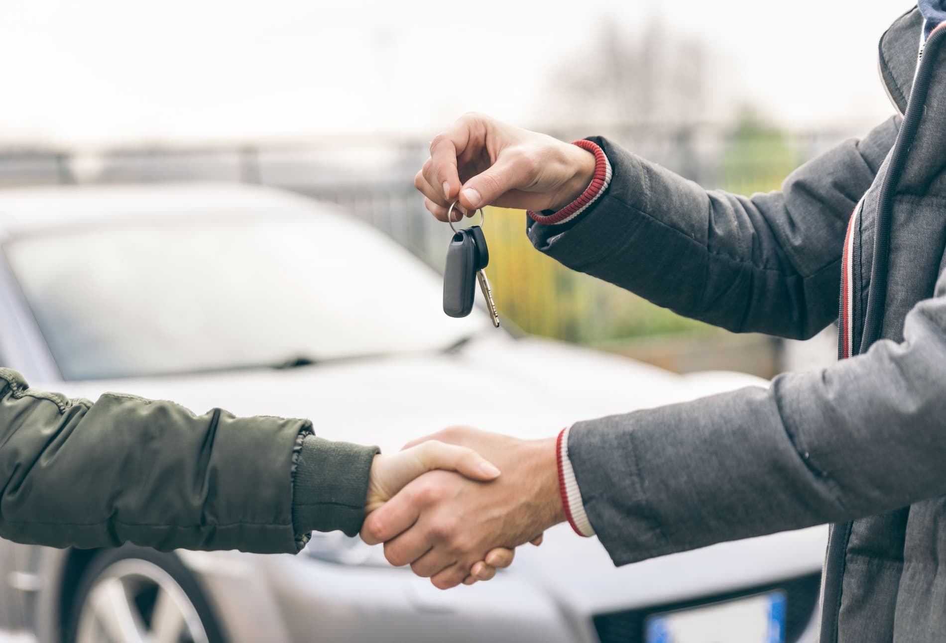 two people reaching an agreement about a car sale royalty free image 1665671206 1